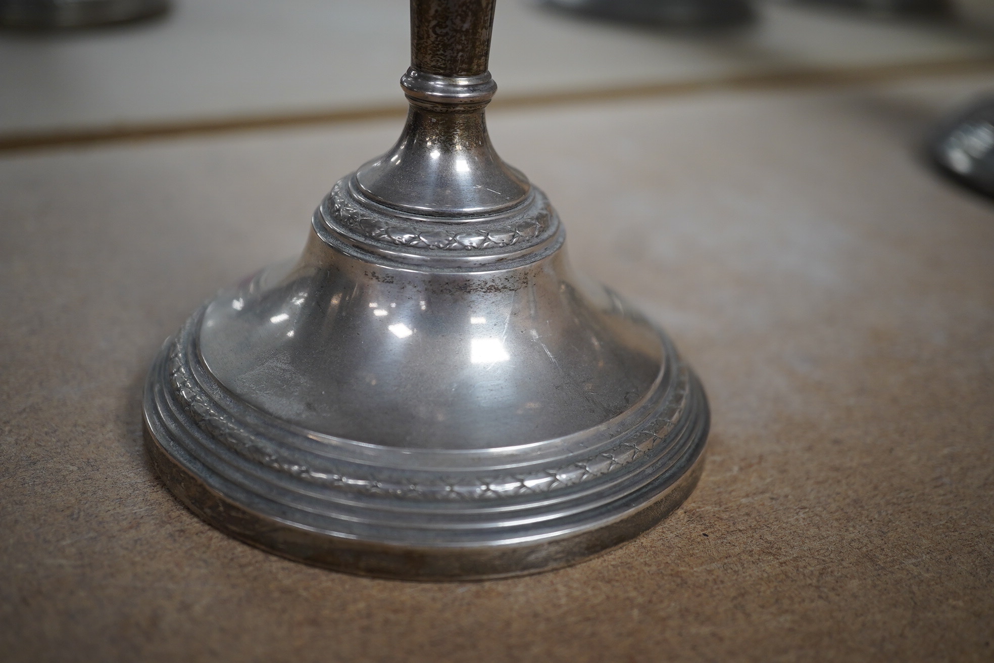 A pair of Elizabeth II silver candlesticks, Broadway & Co, Birmingham, 1960, 25.7cm, weighted, together with a similar silver three light candelabrum, by Adie Bros, weighted. Condition - poor to fair